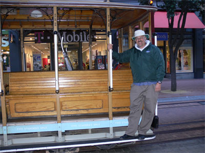 John hanging on the front of the cable car 